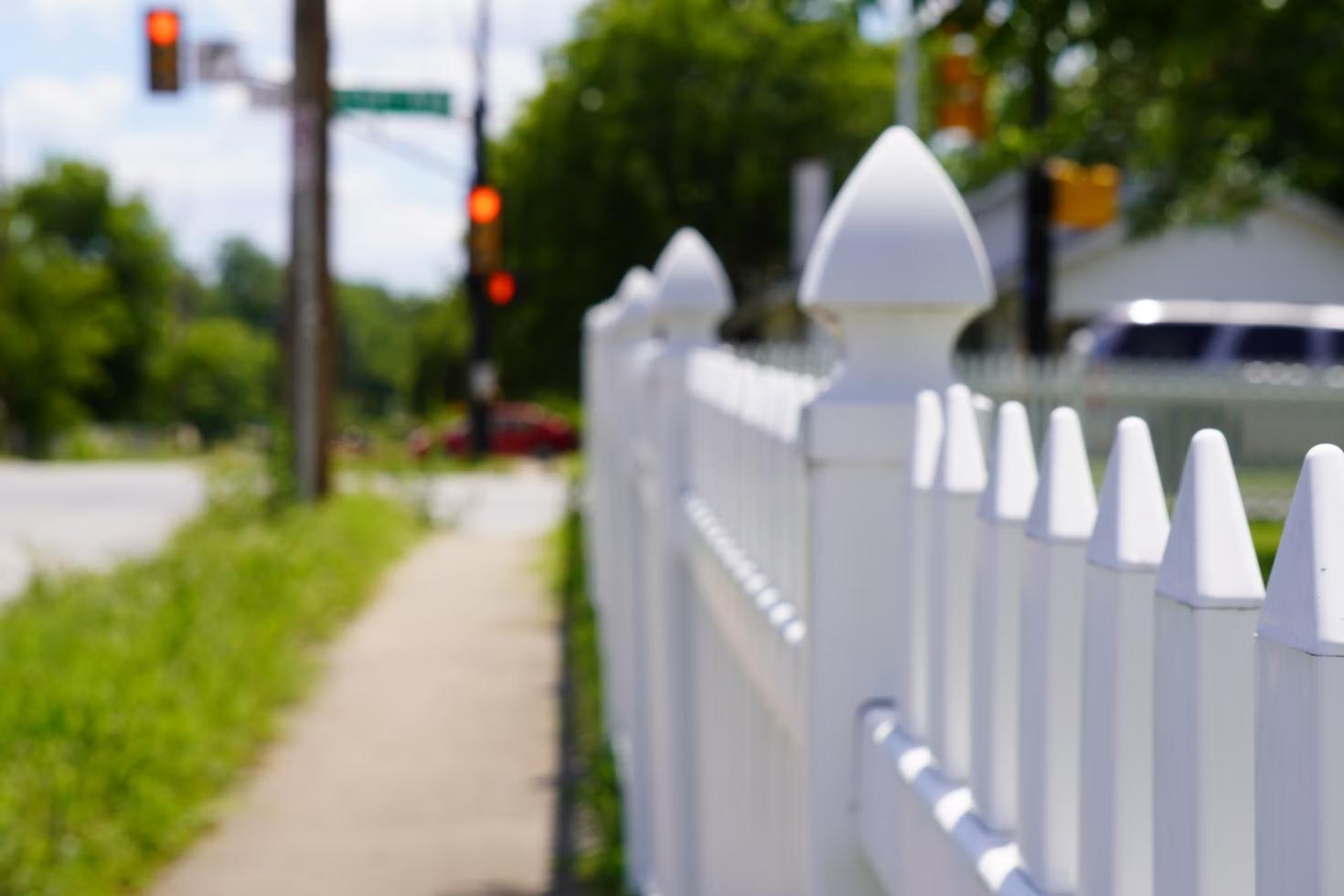  A close-up of a Vinyl fence installed around a house 