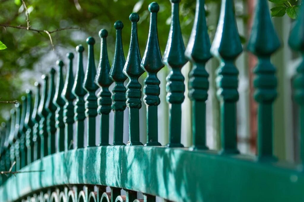 A green metal fence