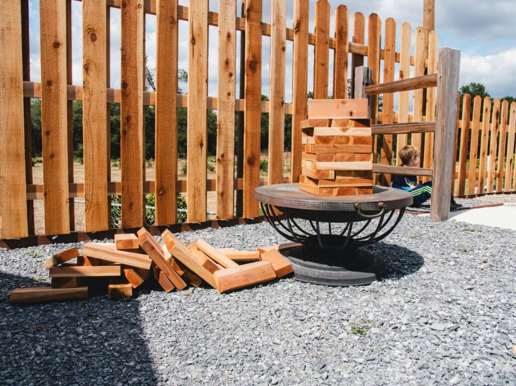 Sturdy wooden fence set atop a sleek grey concrete base, blending rustic charm with contemporary style.