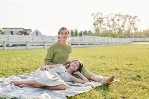 Mother and daughter relaxing near a vinyl fence installed in Harrison Township