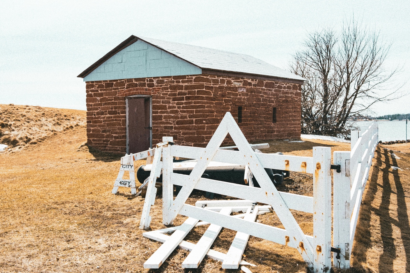 Close-up of a broken vinyl fence panel awaiting repair in Logan Township, New Jersey