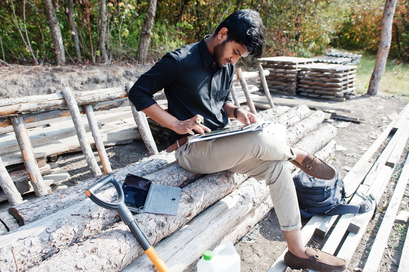Professional fencing contractor measuring residential backyard for installation