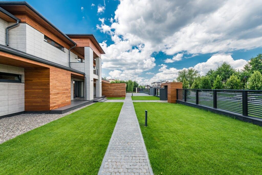 Modern home with sleek black horizontal metal fencing in the front yard for residential fencing in Winslow Township.