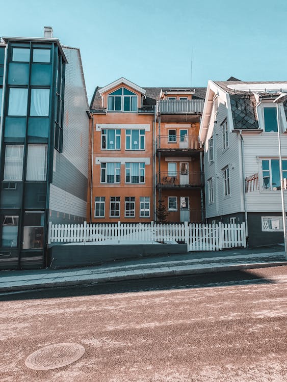 A white fence outside a building